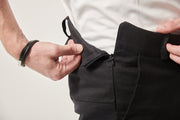 A close up of the side the trousers, showing invisible zip opening at the side seam.